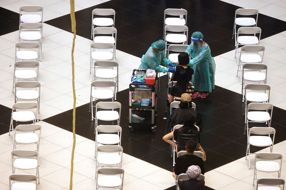 A woman receives a booster shot of the coronavirus disease (COVID-19) vaccine at Taipei main station ahead of Lunar new year in Taipei, Taiwan, January 24, 2022. REUTERS/Ann Wang


