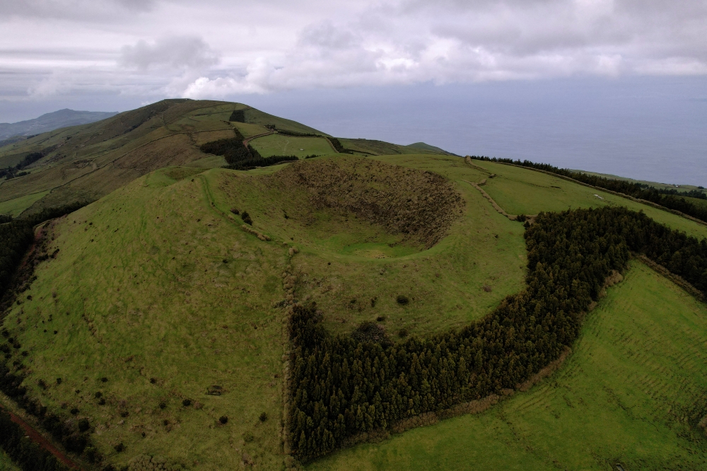 An aerial view shows a volcano crater near Velas as small earthquakes have been recorded on Sao Jorge island, Azores, Portugal, March 30, 2022. Picture taken with a drone. REUTERS/Pedro Nunes/File Photo