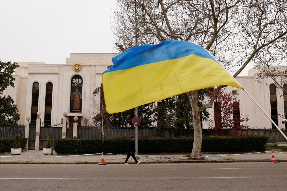 A Ukrainian flag flies outside the Russian embassy, after Spain announced it will expel some 25 Russian diplomats and embassy staff, amid Russia's invasion of Ukraine, in Madrid, Spain, April 5, 2022. REUTERS/Susana Vera