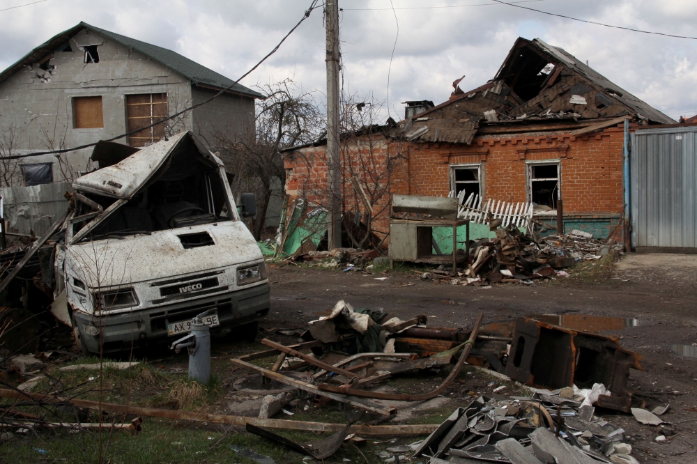  A damaged car and building are seen, amid Russia's invasion of Ukraine, in Kharkiv, April 4, 2022. Reuters/Oleksandr Lapshyn/File Photo