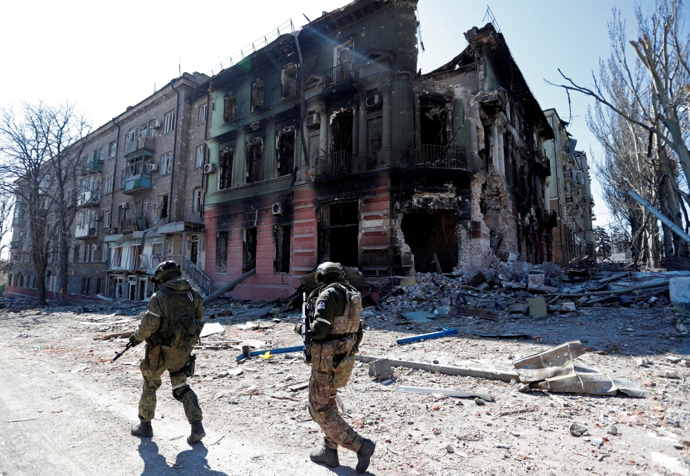 Service members of pro-Russian troops inspect streets during Ukraine-Russia conflict in the southern port city of Mariupol, Ukraine April 7, 2022. Reuters/Alexander Ermochenko/File Photo