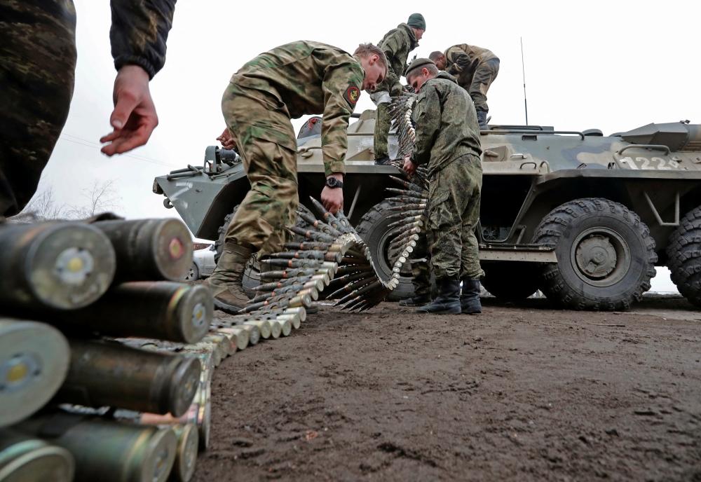 Service members of pro-Russian troops load ammunition into an armoured personnel carrier during fighting in Ukraine-Russia conflict in the southern port city of Mariupol, Ukraine April 12, 2022. REUTERS/Alexander Ermochenko