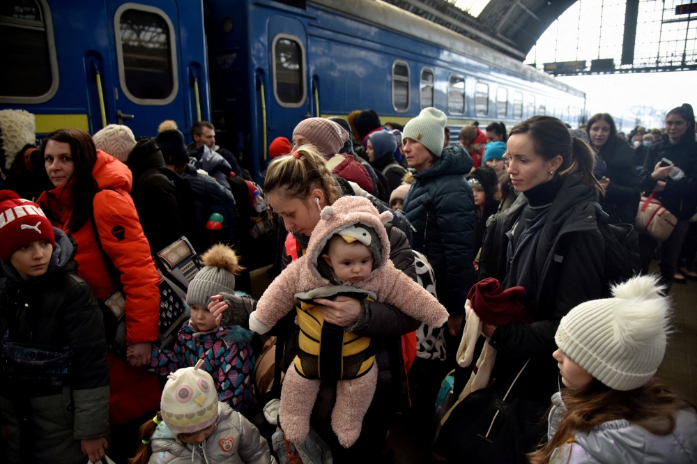 People fleeing Russia's invasion of Ukraine gather at the train station in Lviv, Ukraine, March 9, 2022. REUTERS/Pavlo Palamarchuk/File Photo