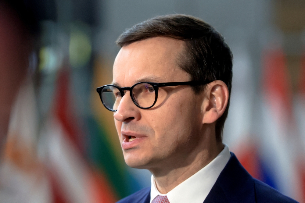 Poland's Prime Minister Mateusz Morawiecki speaks to the media as he arrives for European Union leaders' summit, amid Russia's invasion of Ukraine, in Brussels, Belgium, March 25, 2022. REUTERS/Wolfgang Rattay/File Photo