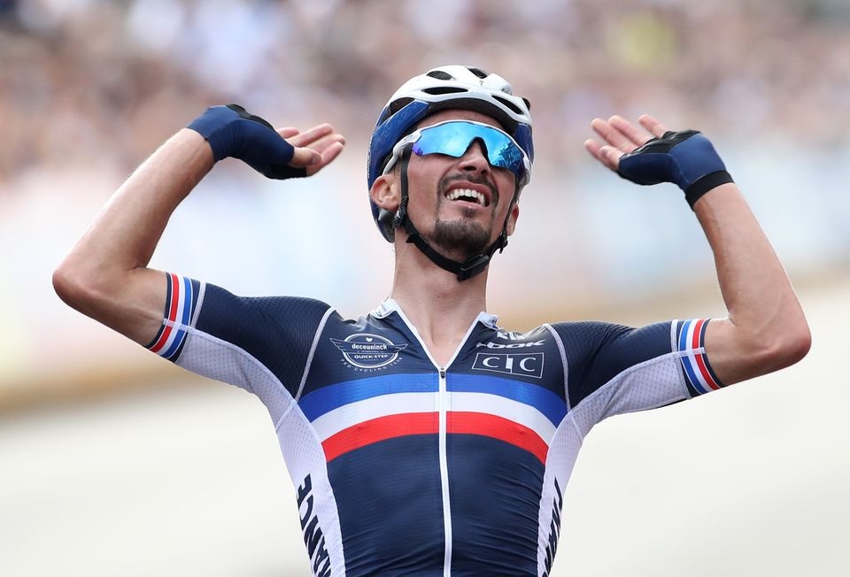 September 26, 2021 France's Julian Alaphilippe celebrates as he crosses the line to win the race REUTERS/Yves Herman