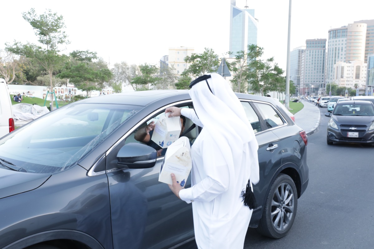 Iftar boxes being distributed in a street.