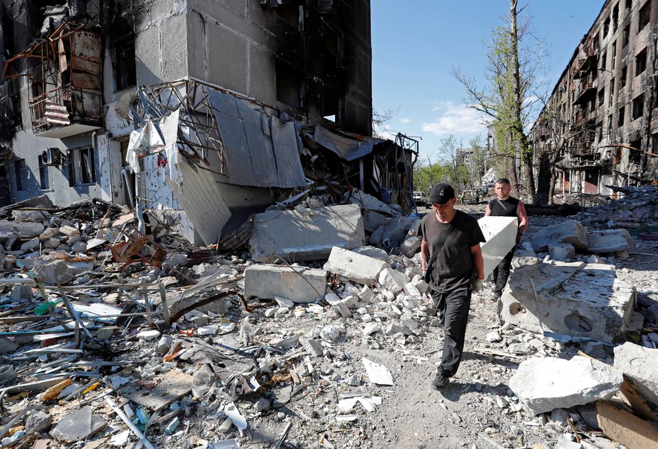 Local residents take furniture out of an apartment building heavily damaged during Ukraine-Russia conflict in the southern port city of Mariupol, Ukraine April 28, 2022. Picture taken April 28, 2022. REUTERS/Alexander Ermochenko


