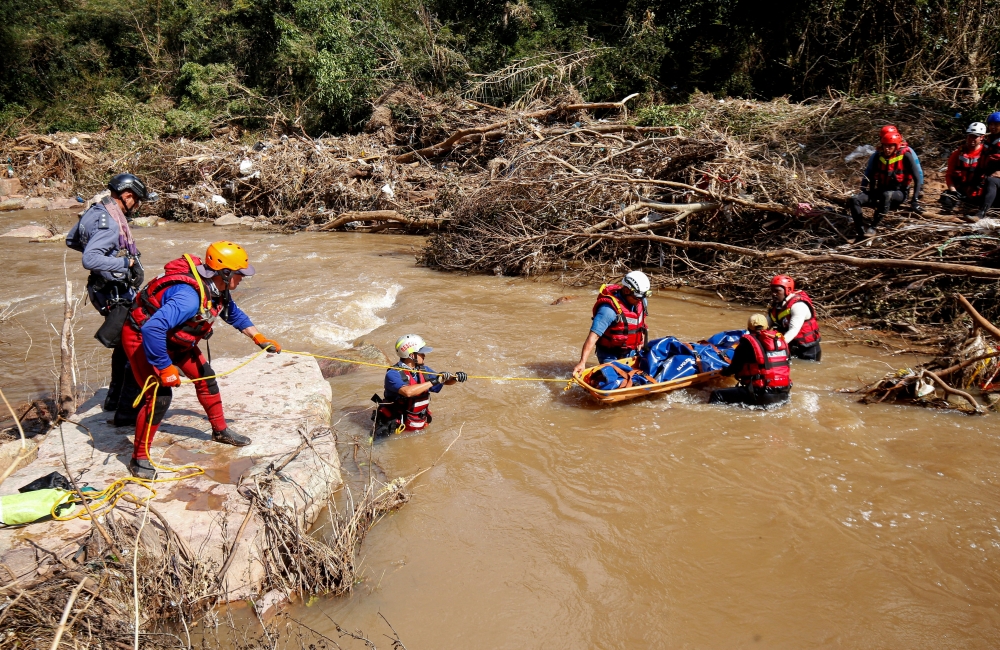 A search and rescue team prepares to airlift a body from the Mzinyathi River after heavy rains caused flooding near Durban, South Africa, April 19, 2022. REUTERS/Rogan Ward

