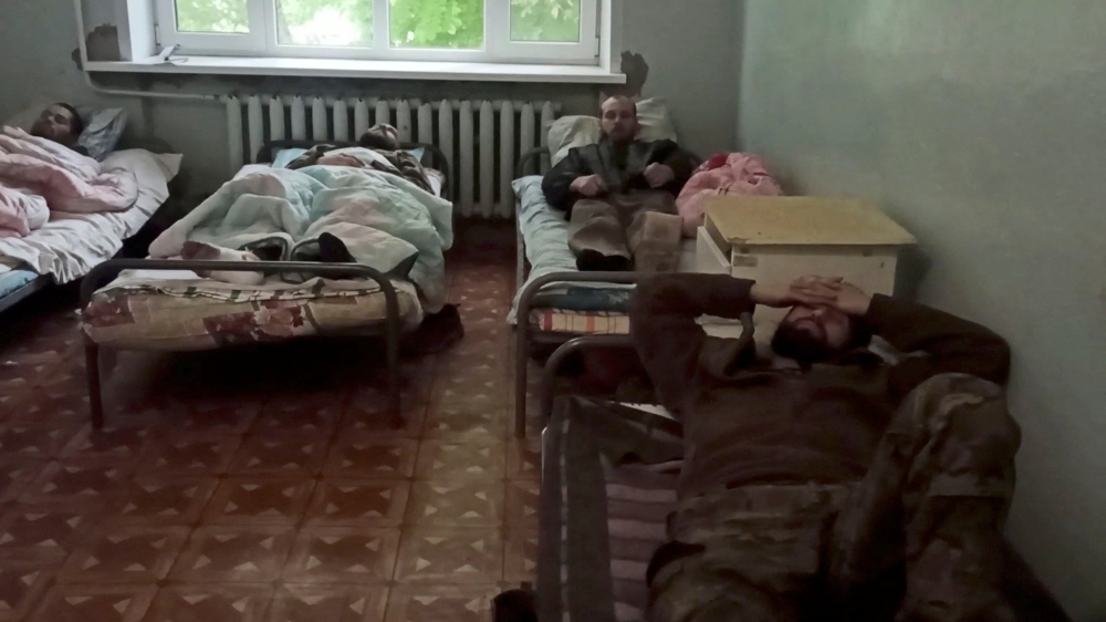 A still image taken from a handout video released by Russian Defence Ministry shows what it says are Ukrainian service members receiving hospital treatment after surrendering at the besieged Azovstal steelworks, in Novoazovsk, Ukraine. Video released May 18, 2022. Russian Defence Ministry/Handout via REUTERS 