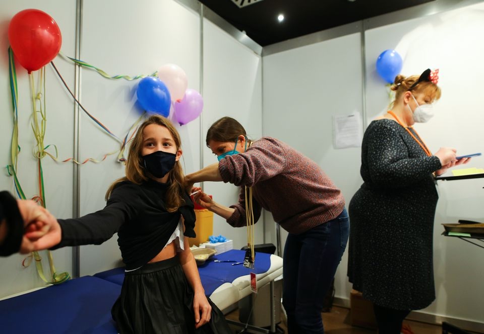 Eleven-year-old Chiara receives a dose of the Pfizer-BioNTech vaccine for children against the coronavirus disease (COVID-19) during a vaccination event for children at the Lanxess Arena in Cologne, Germany, December 18, 2021. REUTERS/Thilo Schmuelgen

