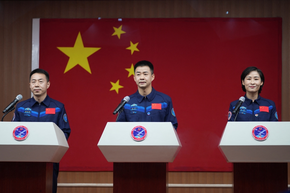 Chinese astronauts Cai Xuzhe, Chen Dong and Liu Yang attend a news conference before the Shenzhou-14 spaceflight mission. China Daily via Reuters 