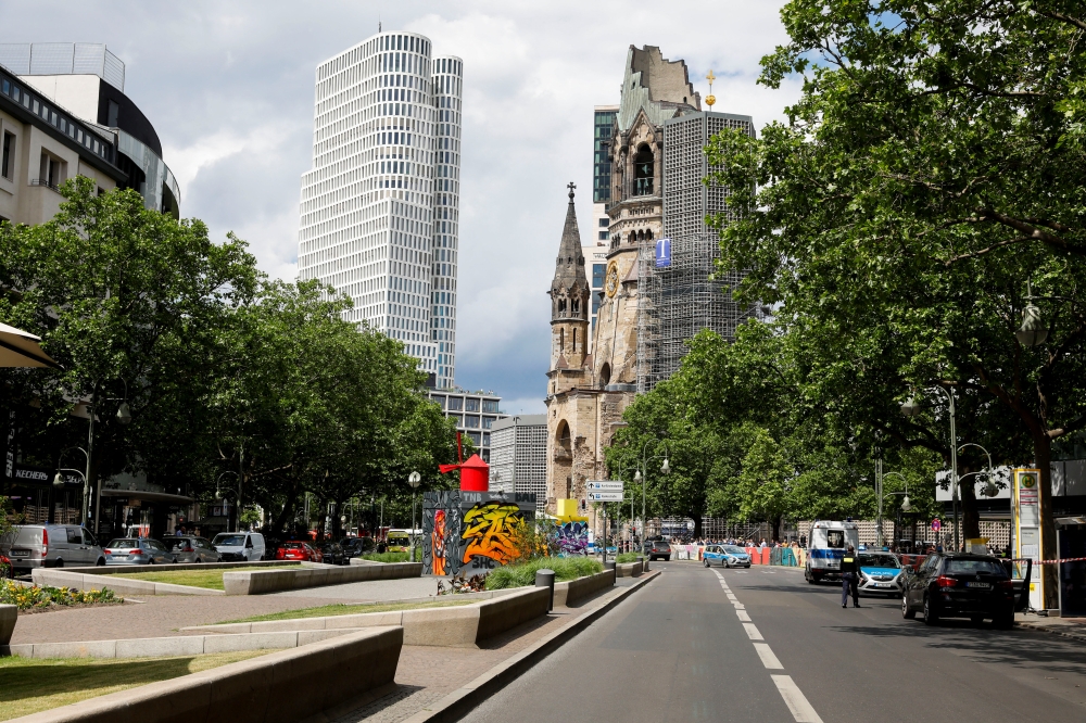 A police officer and police vehicles are seen on Tauentzienstrasse, near the the scene where a car crashed into a group of people, in Berlin, Germany, June 8, 2022. REUTERS/Michele Tantussi