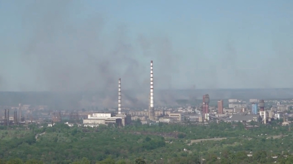 Black smoke billows over Sievierodonetsk Azot chemical plant as Russia's invasion on Ukraine continues, in Sievierodonetsk, Luhansk Region, Ukraine, in this still image obtained from a handout video released on June 9, 2022. Luhansk Region Police