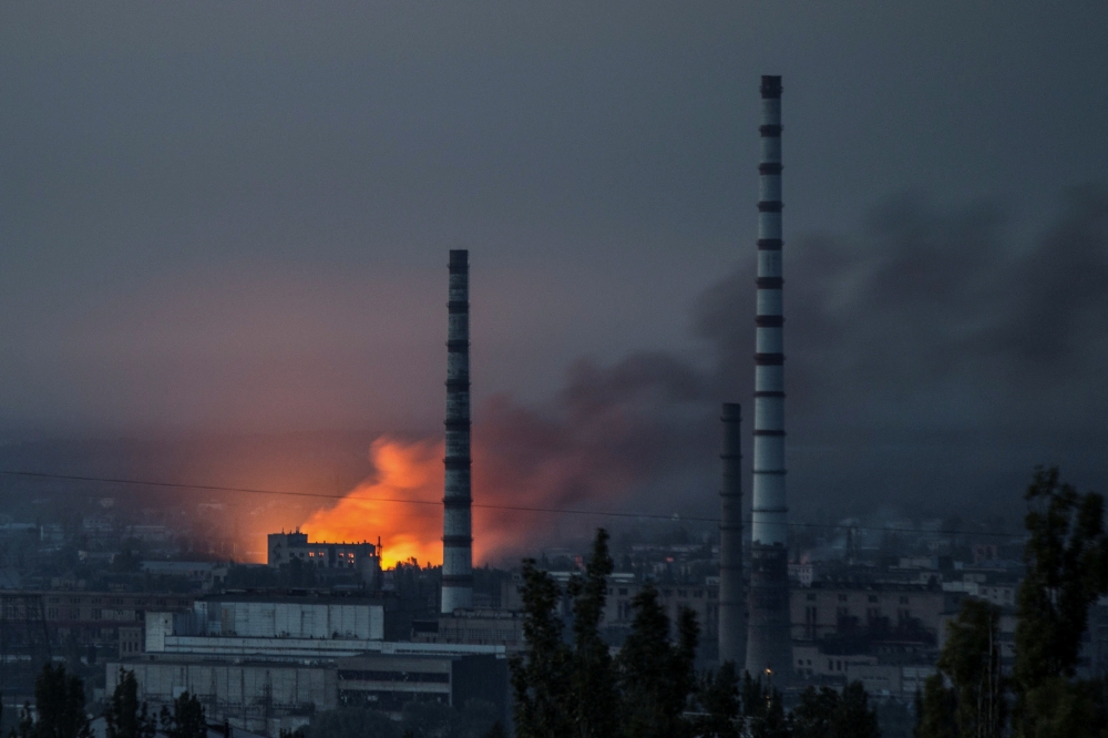 Smoke and flame rise after a military strike on a compound of Sievierodonetsk's Azot Chemical Plant, as Russia's attack on Ukraine continues, in Lysychansk, Luhansk region, Ukraine on June 18, 2022. Reuters