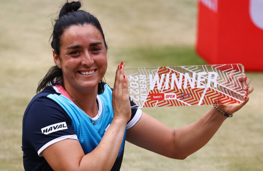 Tunisia's Ons Jabeur celebrates with the trophy after winning her final match against Switzerland's Belinda Bencic REUTERS/Christian Mang