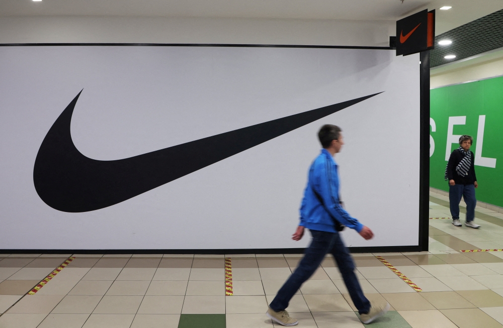 People walk past a closed store of the sporting goods retailer Nike at a shopping mall in Saint Petersburg, Russia, recently. Reuters/Anton Vaganov/File Photo