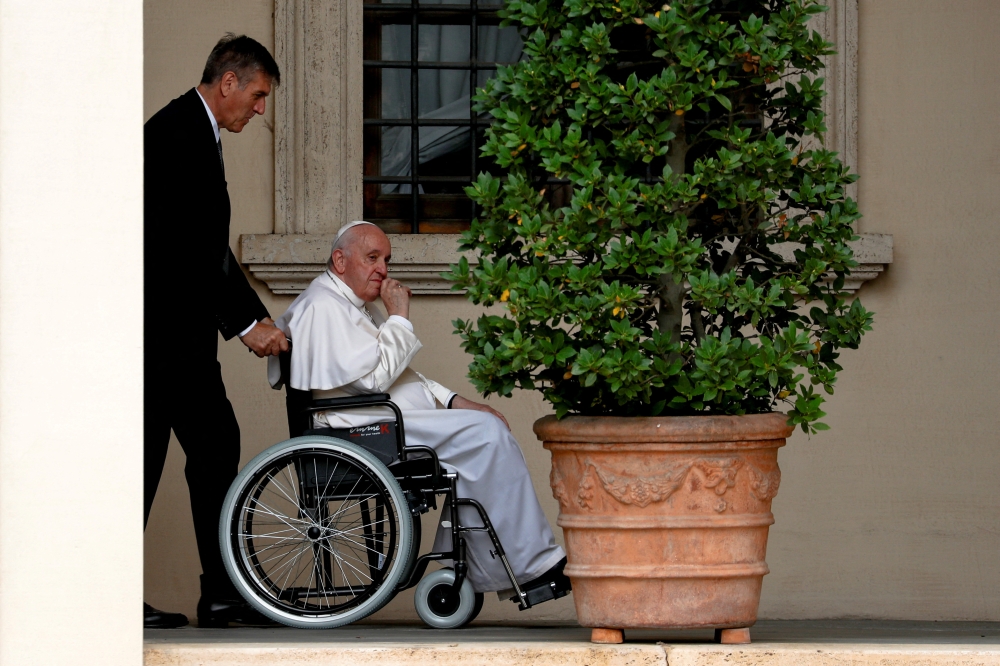Pope Francis arrives in a wheelchair to meet children with disabilities and Ukrainian children who fled their country, at the Vatican, recently. (Reuters)