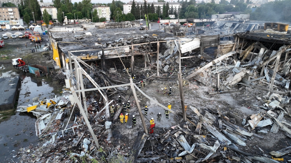 Rescuers work at a site of a shopping mall hit by a Russian missile strike in Kremenchuk, in Poltava region, Ukraine, in this handout picture released June 28, 2022. Press service of the State Emergency Service of Ukraine/Handout via Reuters 