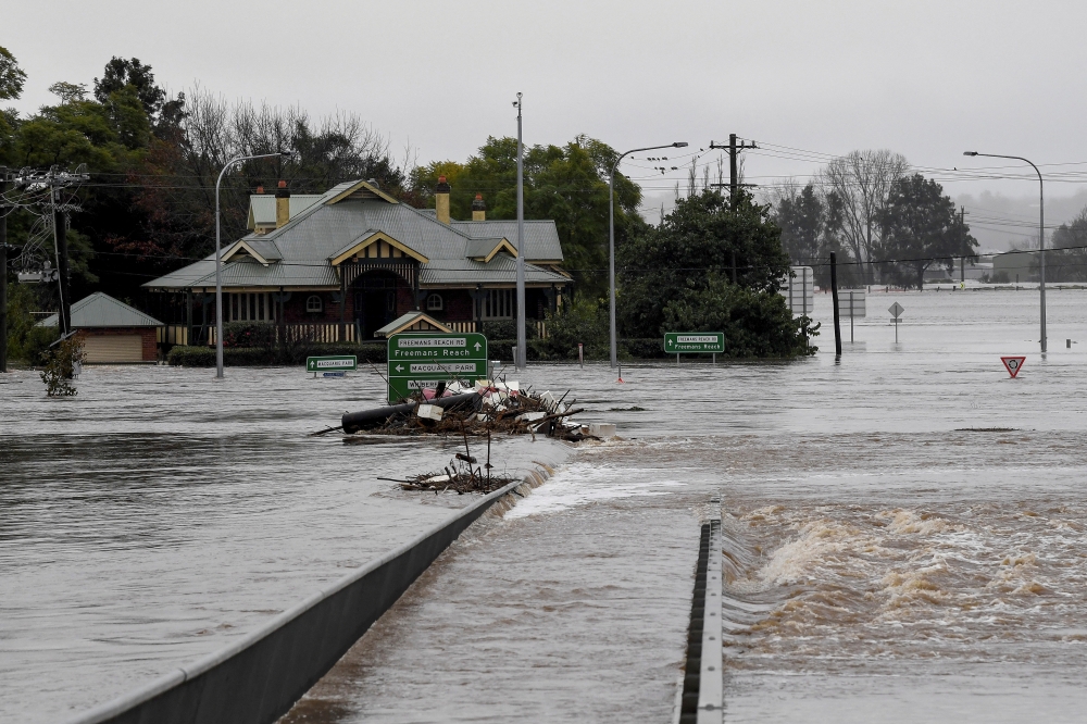 Debris is seen as the Windsor Bridge is submerged under floodwater from the swollen Hawkesbury River in Windsor, north west of Sydney, Australia, July 4, 2022. AAP Image/Bianca De Marchi via REUTERS