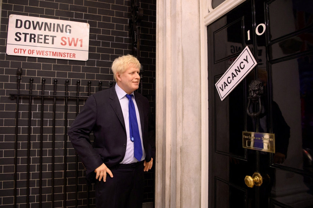 A wax figure of Boris Johnson is pictured next to a 'vacancy' sign on 10 Downing Street at Madame Tussauds, in London, Britain July 7, 2022. (Madame Tussauds London)