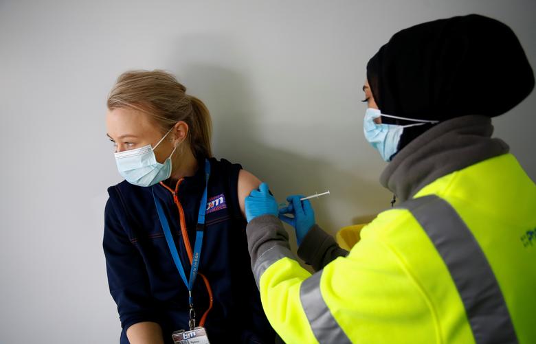 File photo: A woman receives vaccine against COVID-19 at a vaccination centre in Blackburn, Britain. (REUTERS/Jason Cairnduff)

