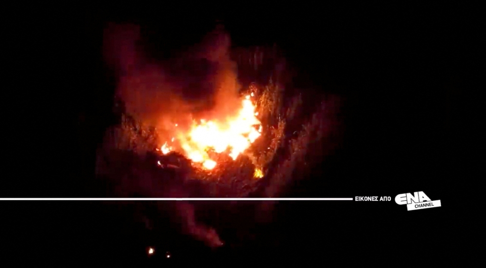 A drone view shows the burning debris at the crash site of an Antonov An-12 cargo plane owned by a Ukrainian company, near Kavala, Greece, July 16, 2022. ENA Channel/Handout via REUTERS ATTENTION EDITORS- THIS IMAGE HAS BEEN SUPPLIED BY A THIRD PARTY. MANDATORY CREDIT NO RESALES. NO ARCHIVES. MUST NOT OBSCURE LOGO