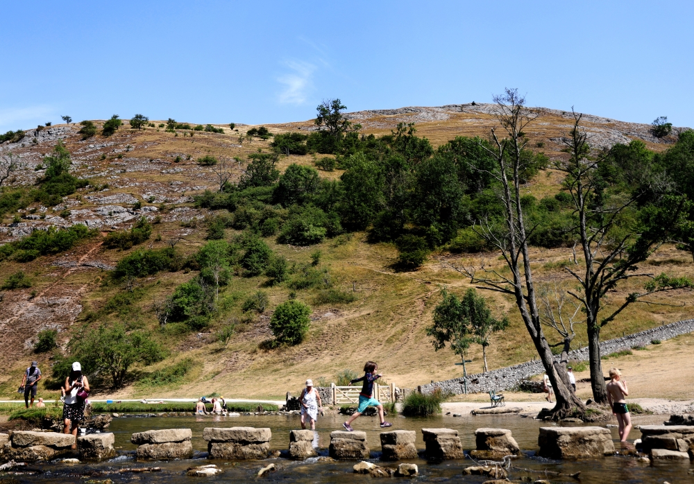 People play in the River Dove in Dovedale during the heatwave, Derbyshire, Britain, July 19, 2022. REUTERS/Carl Recine