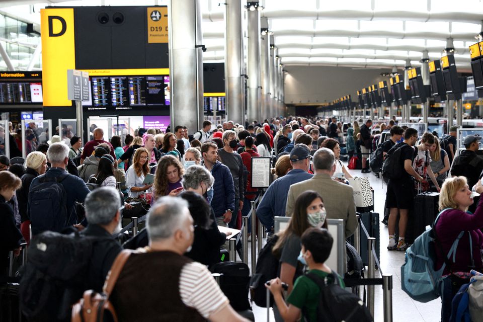Passengers queue inside the departures terminal of Terminal 2 at Heathrow Airport in London, Britain, June 27, 2022. REUTERS/Henry Nicholls/File Photo


