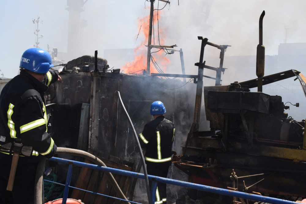 Firefighters work at a site of a Russian missile strike in a sea port of Odesa, as Russia's attack on Ukraine continues, Ukraine July 23, 2022. (Handout via REUTERS)
