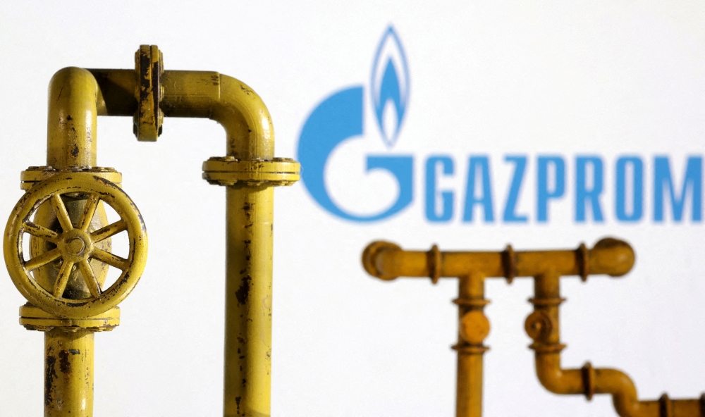 Model of natural gas pipeline and Gazprom logo, July 18, 2022. (REUTERS/Dado Ruvic/Illustration)