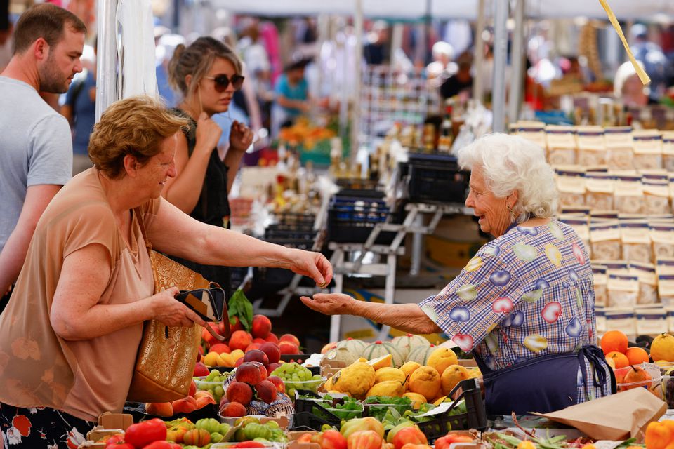A woman shops at Campo de' Fiori market, on the day the European Central Bank's rate-setting Governing Council holds an unscheduled meeting to discuss the recent sell-off in government bond market, in Rome, Italy, June 15, 2022. REUTERS/Guglielmo Mangiapane