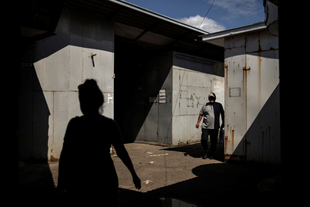People make their way at the partially-closed Market of Kramatorsk, as Russia's attack on Ukraine continues, in Kramatorsk, Ukraine, August 4, 2022. REUTERS/Alkis Konstantinidis