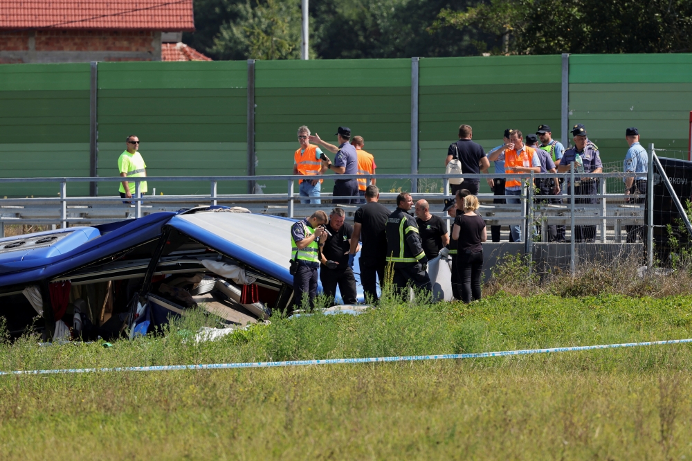 Rescuers work at the scene where a bus with Polish licence plates slipped off a road near Varazdin, northwestern Croatia, August 6, 2022. REUTERS/Antonio Bronic