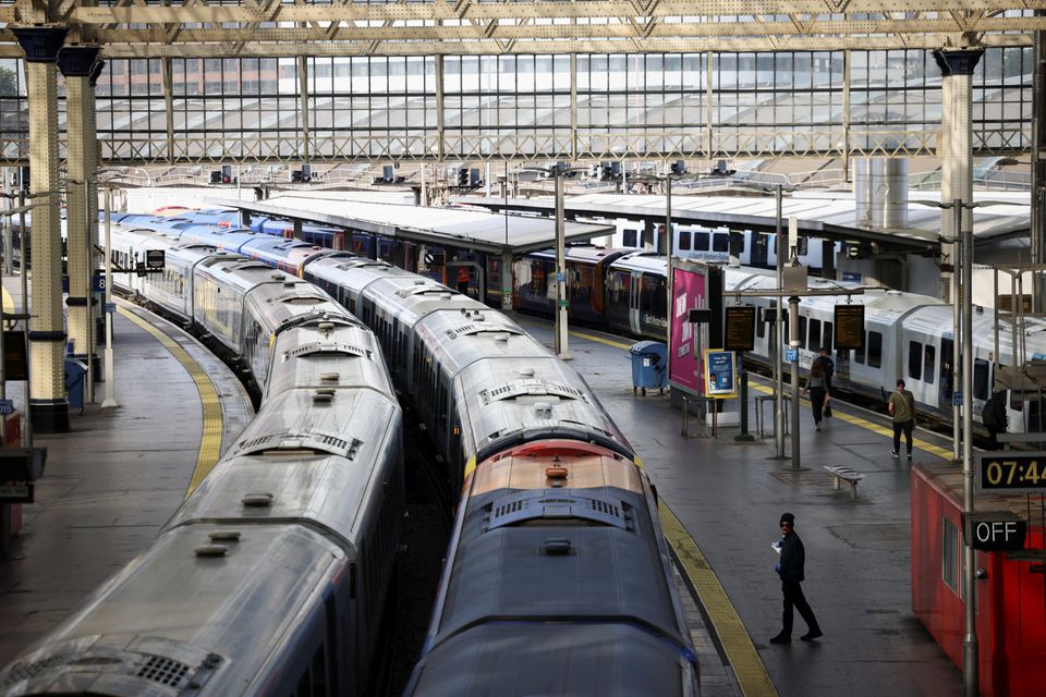 File Photo: A view of trains on the platform at Waterloo Station as a station worker stands nearby, on the first day of national rail strike in London, Britain, June 21, 2022. (REUTERS/Henry Nicholls)

