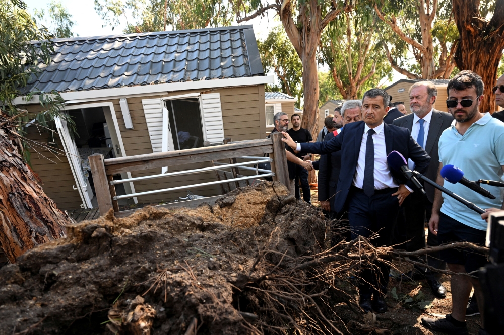 France's Interior Minister Gerald Darmanin stands next to a damaged bungalow in the aftermath of a hurricane at La Pinede camping site in Calvi in the French Mediterranean island of Corsica August 19, 2022. Emmanuel Dunand/Pool via REUTERS