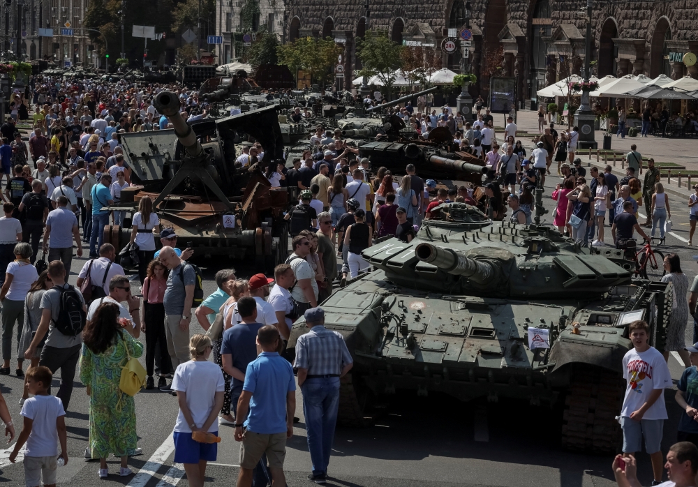 People attend an exhibition displaying destroyed Russian military vehicles located on the main street Khreshchatyk as part of the upcoming celebration of the Independence Day of Ukraine, amid Russia's invasion, in central Kyiv, Ukraine August 21, 2022. REUTERS/Gleb Garanich