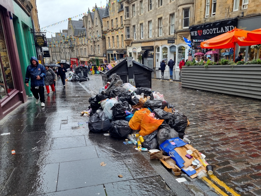 Waste is overflowing from bins on a street amid a strike by waste services workers in Edinburgh, Scotland, Britain, August 26, 2022. (REUTERS/Andy Bruce)