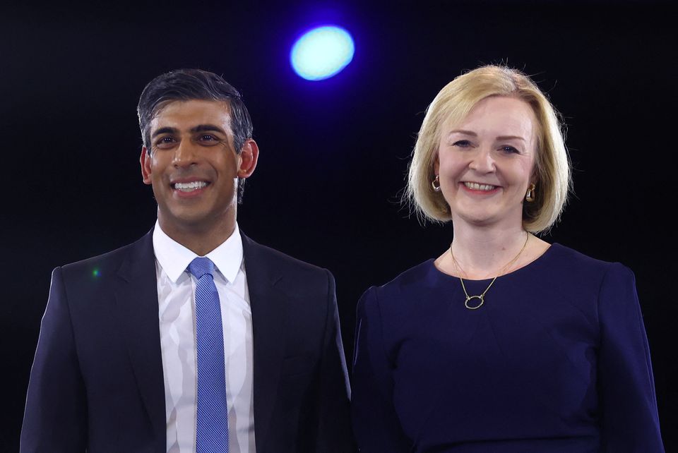 Conservative leadership candidates Liz Truss and Rishi Sunak stand together as they attend a hustings event, part of the Conservative party leadership campaign, in London, on August 31, 2022. REUTERS/Hannah McKay/File Photo