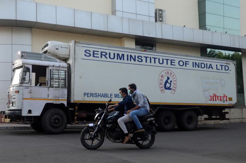 Men ride on a motorbike past a supply truck of India's Serum Institute, the world's largest maker of vaccines, which is working on a vaccine against the coronavirus disease (COVID-19) in Pune, India, on May 18, 2020. File Photo / Reuters
