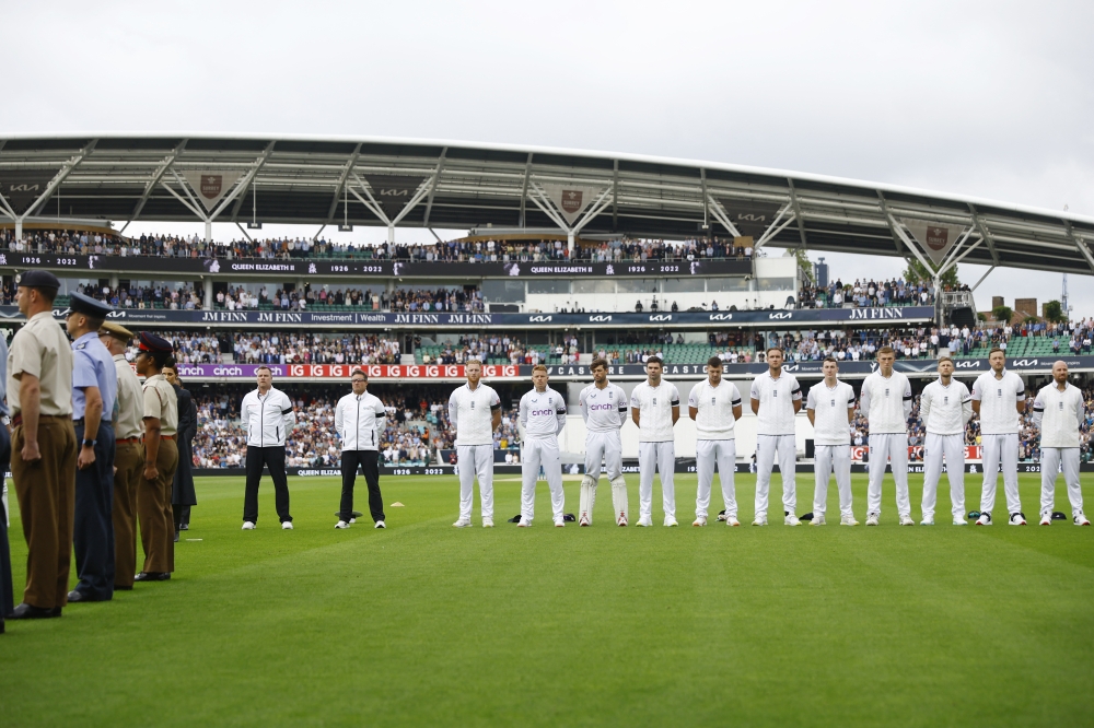Members of military and players wearing black armbands stand during a minutes silence before the match following the passing of Britain's Queen Elizabeth Action Images via Reuters/Andrew Boyers
