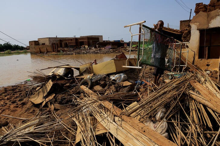A man collects his belongings after sustaining water damage to his house during floods in Al-Managil locality, in Jazeera State, Sudan, on August 23, 2022. REUTERS/Mohamed Nureldin Abdallah