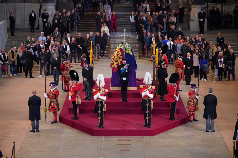 Queen Elizabeth II 's grandchildren (clockwise from front centre) the Prince of Wales, Peter Phillips, James, Viscount Severn, Princess Eugenie, the Duke of Sussex, Princess Beatrice, Lady Louise Windsor and Zara Tindall hold a vigil beside the coffin of their grandmother as it lies in state on the catafalque in Westminster Hall, at the Palace of Westminster, London, on Saturday September 17, 2022.  Yui MokPA Wire Yui Mok/Pool via REUTERS