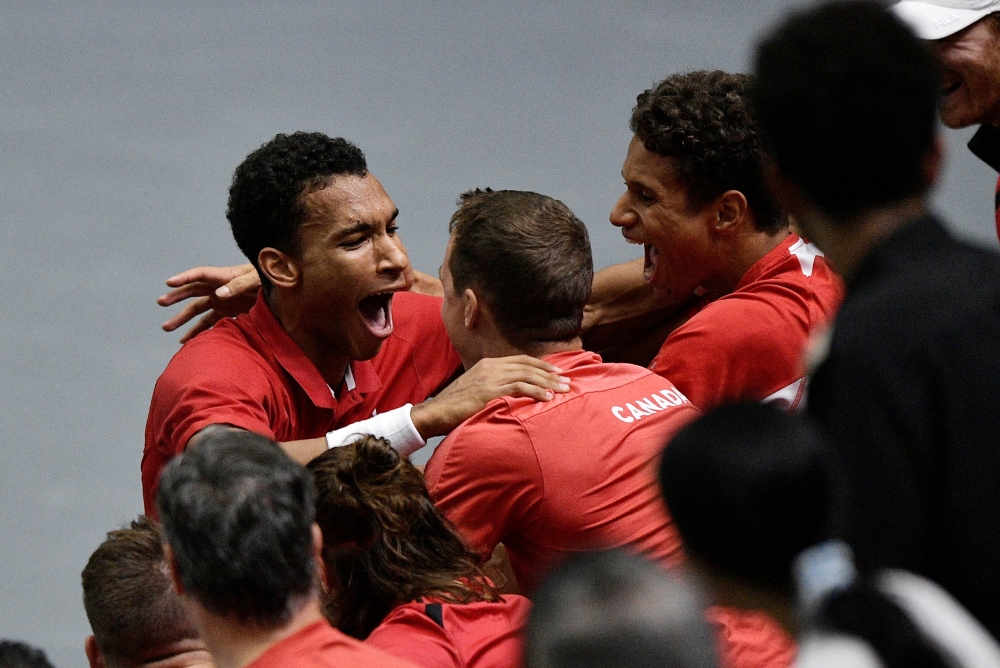 Canada's Felix Auger Aliassime celebrates with his team after winning his Davis Cup Group B match against Serbia's Miomir Kecmanovic  at the  Pavello Municipal Font de Sant Lluis in Valencia, Spain, on September 17, 2022.   REUTERS/Pablo Morano