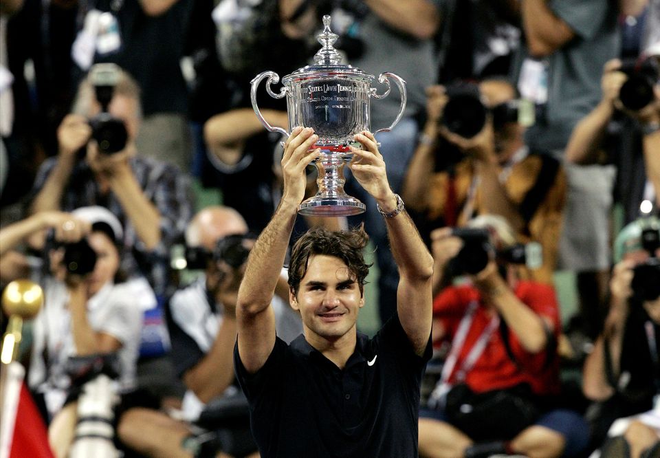 Roger Federer of Switzerland holds up the trophy in front of photographers after winning his match against Novak Djokovic of Serbia in the men's final of the US Open in Flushing Meadows, New York, on September 9, 2007. File Photo / Reuters
