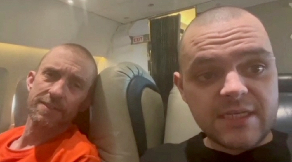 British Prisoners of war (POWs) sit in a flight following their release from Russian captivity after fighting for Ukraine, amid Russia's attack on Ukraine, in this screen grab of a video obtained from social media. Instagram/cossackgundi/via Reuters 