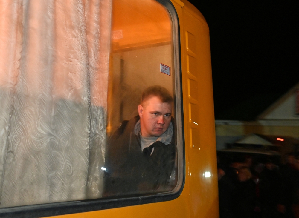 A reservist drafted during the partial mobilisation looks out of a bus window outside a recruitment office in the Siberian town of Tara in the Omsk region, Russia September 26, 2022. Reuters/Alexey Malgavko