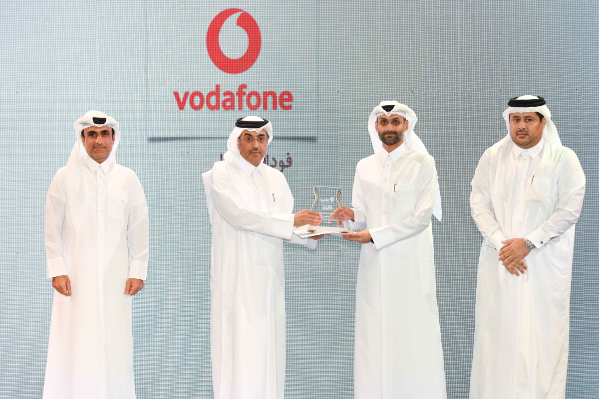 Minister of Labor H E Dr. Ali bin Saeed bin Smaikh Al Marri presents the award to Chief Human Resources Officer at Vodafone Qatar Khames Mohammed Alnaimi, during the awards ceremony, yesterday. 