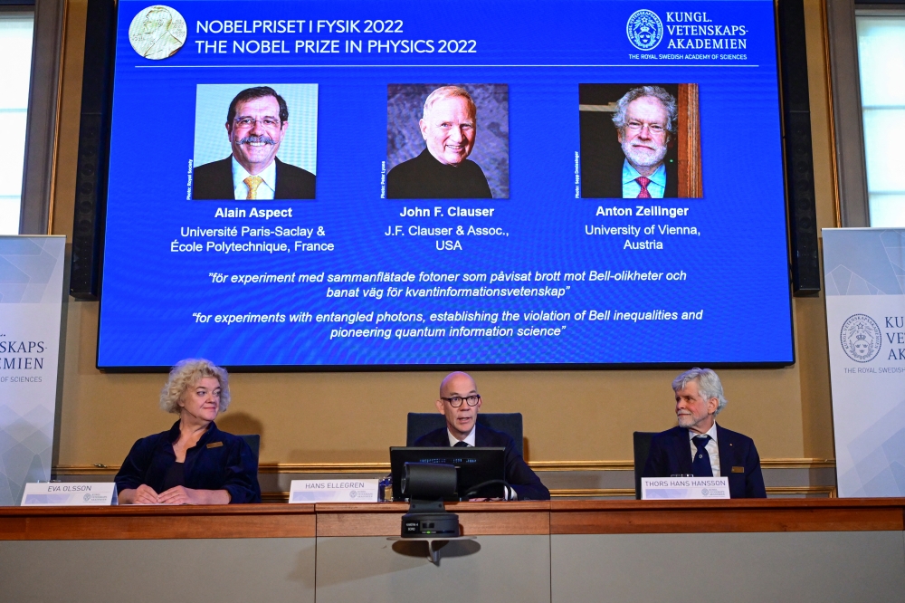 Secretary General of the Royal Swedish Academy of Sciences Hans Ellegren, Eva Olsson and Thors Hans Hansson, members of the Nobel Committee for Physics announce the winners of the 2022 Nobel Prize in Physics Alain Aspect, John F. Clauser and Anton Zeilinger, during a news conference at The Royal Swedish Academy of Sciences in Stockholm, Sweden, October 4, 2022. TT News Agency/ Jonas Ekstromervia REUTERS
