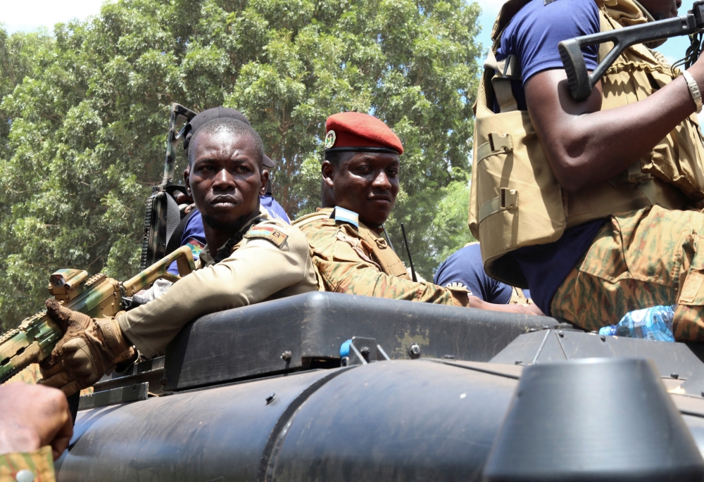 Burkina Faso's new military leader Ibrahim Traore is escorted by soldiers while he stands in an armoured vehicle in Ouagadougou, Burkina Faso, on October 2, 2022. REUTERS/Vincent Bado 