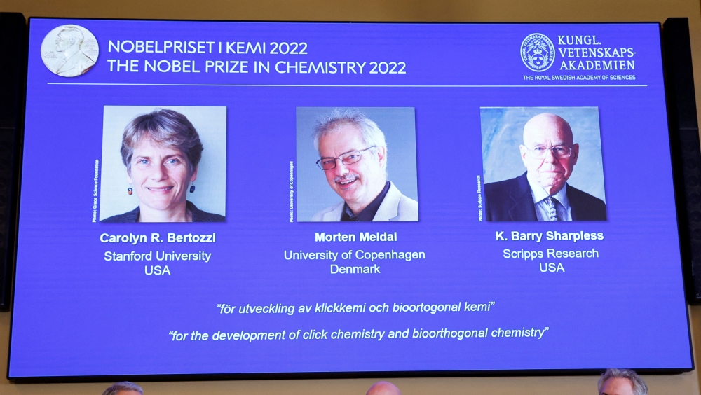 Screens show winners Carolyn R. Bertozzi (US), Morten Meldal (Denmark) and K Barry Sharpless (US) of the 2022 Nobel Prize in Chemistry during a news conference at The Royal Swedish Academy of Sciences in Stockholm, Sweden, October 5, 2022. TT News Agency/Christine Olsson via Reuters 